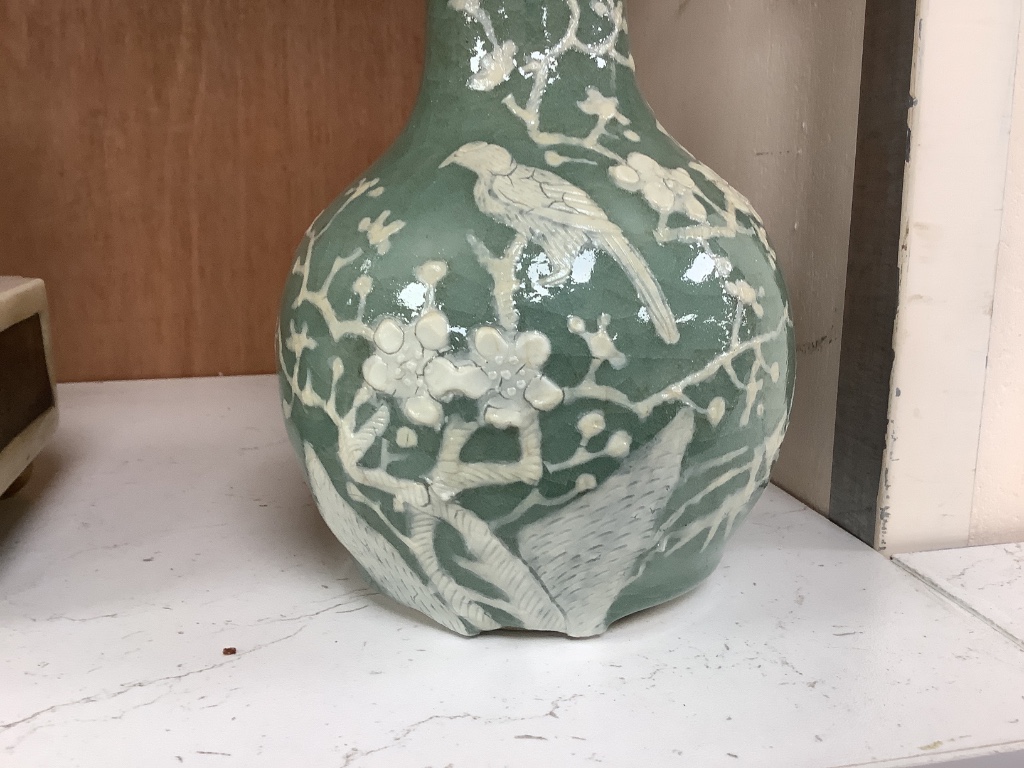 A Chinese celadon bottle vase with white slip decoration, 19th/20th century, height 20cm